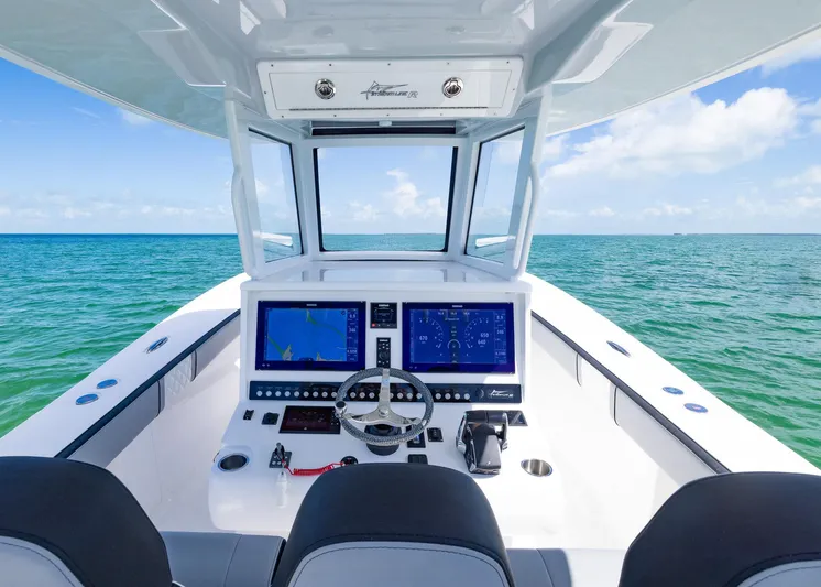  Yacht Photos Pics 2025 Streamline R 35 boat cockpit with dual screens, steering wheel, and ocean view.