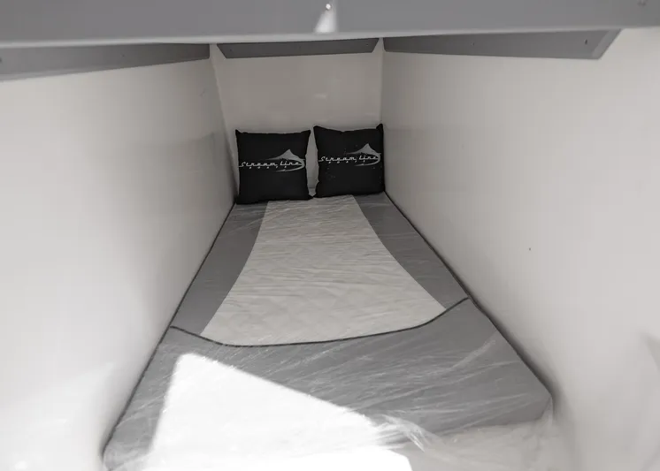  Yacht Photos Pics Compact sleeping area in 2025 Streamline R 35 with pillows and mattress.
