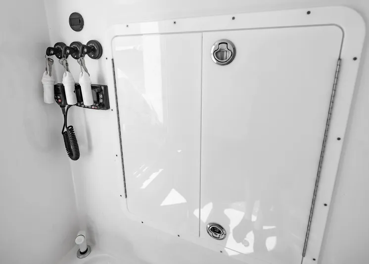  Yacht Photos Pics 2025 Streamline R 35 boat storage compartment with hooks and coiled cable.