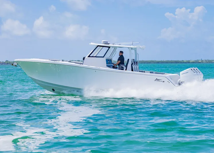  Yacht Photos Pics 2025 Streamline R 35 boat cruising on clear blue water under a sunny sky.