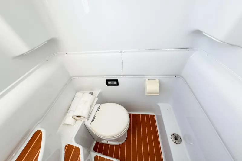  Yacht Photos Pics 2012 Yellowfin 39 Offshore boat bathroom with wooden flooring and compact toilet.