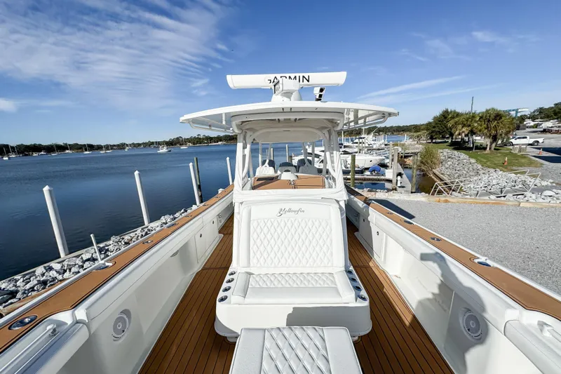  Yacht Photos Pics 2012 Yellowfin 39 Offshore boat docked by a scenic waterfront.
