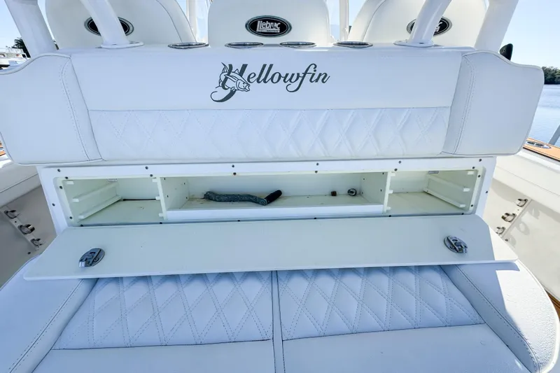  Yacht Photos Pics 2012 Yellowfin 39 Offshore boat with open storage compartment and white cushioned seating.