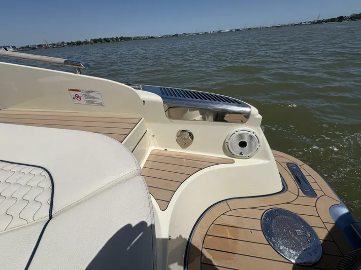  Yacht Photos Pics 2023 Chris-Craft Launch 31 GT boat, featuring elegant deck design and luxurious seating by the water.