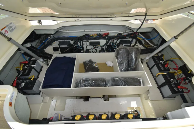  Yacht Photos Pics Engine compartment of 2023 Chris-Craft Launch 31 GT, showcasing batteries and wiring.