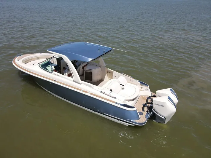  Yacht Photos Pics 2023 Chris-Craft Launch 31 GT boat on calm water, featuring sleek design and dual outboard engines.