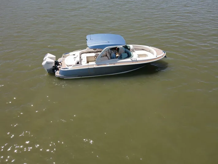  Yacht Photos Pics 2023 Chris-Craft Launch 31 GT boat on calm water, featuring sleek design and modern amenities.