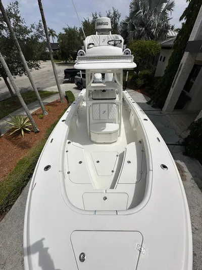  Yacht Photos Pics 2019 Young 27 boat with Simrad electronics, docked near palm trees.