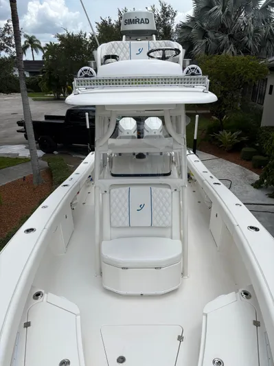  Yacht Photos Pics Young 27 boat, 2019 model, featuring a sleek white deck and advanced navigation equipment.