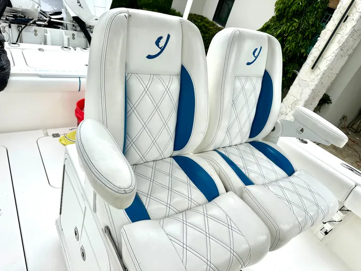  Yacht Photos Pics Luxury boat seats with white and blue upholstery, featuring diamond stitching, 2019 Young 27 model.
