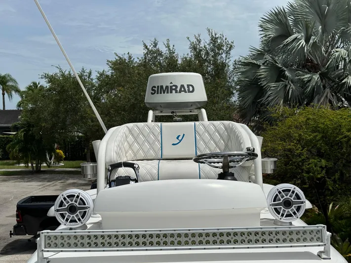  Yacht Photos Pics Luxury boat helm with Simrad system, Young 27 model, 2019, surrounded by lush greenery.