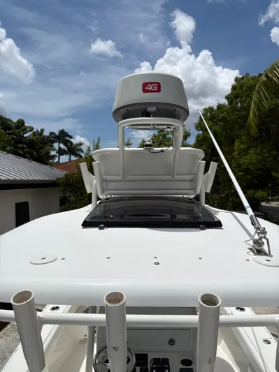  Yacht Photos Pics Young 27 boat with radar and antenna under a clear blue sky, 2019 model.