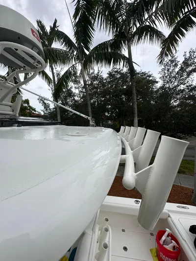  Yacht Photos Pics 2019 Young 27 boat with rod holders, palm trees in background.