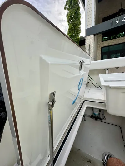 Yacht Photos Pics Open storage compartment on a 2019 Young 27 boat, showcasing interior details.