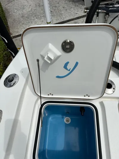  Yacht Photos Pics Open hatch on a 2019 Young 27 boat, revealing a blue compartment.