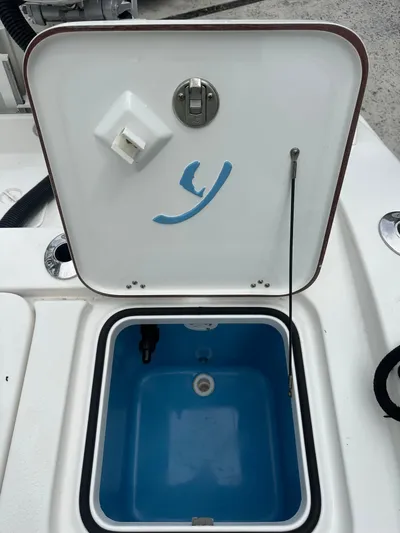  Yacht Photos Pics Open hatch on a 2019 Young 27 boat, revealing a blue interior compartment.