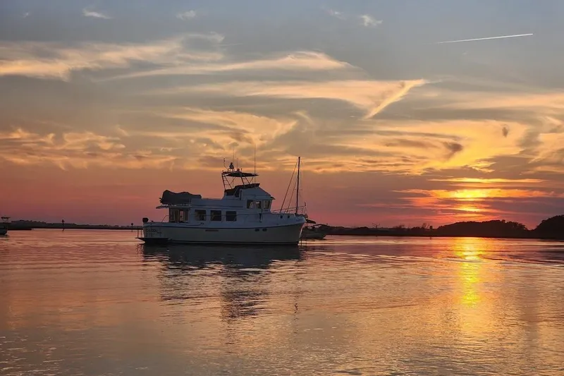 Chinook Yacht Photos Pics American Tug 49 Limited 2010 at sunset on tranquil water.
