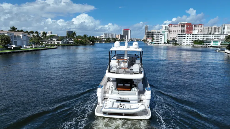 Triangle Of The Seas Yacht Photos Pics Azimut Magellano 66 yacht cruising in a scenic urban waterway, 2022 model.