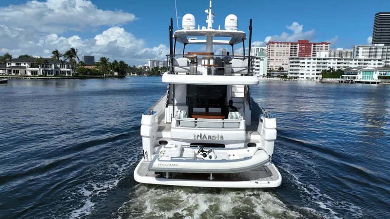 Triangle Of The Seas Yacht Photos Pics Azimut Magellano 66 yacht, 2022 model, cruising in a scenic waterfront area.