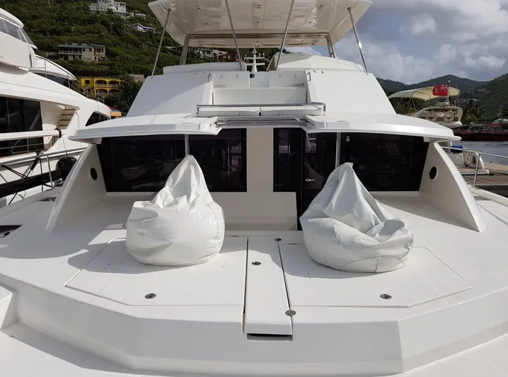 Dash Away Yacht Photos Pics 2015 Leopard 51 Powercat yacht with bean bags on deck, docked in a scenic marina.