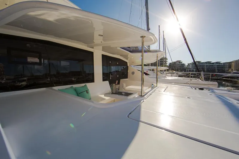 Dash Away Yacht Photos Pics 2015 Leopard 51 Powercat yacht deck with modern design and sunlit seating area.
