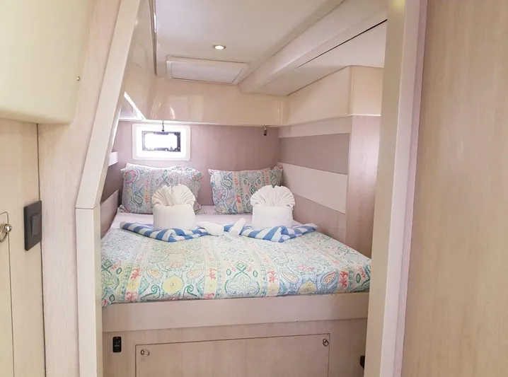 Dash Away Yacht Photos Pics Cozy bedroom in 2015 Leopard 51 Powercat with colorful bedding and soft lighting.