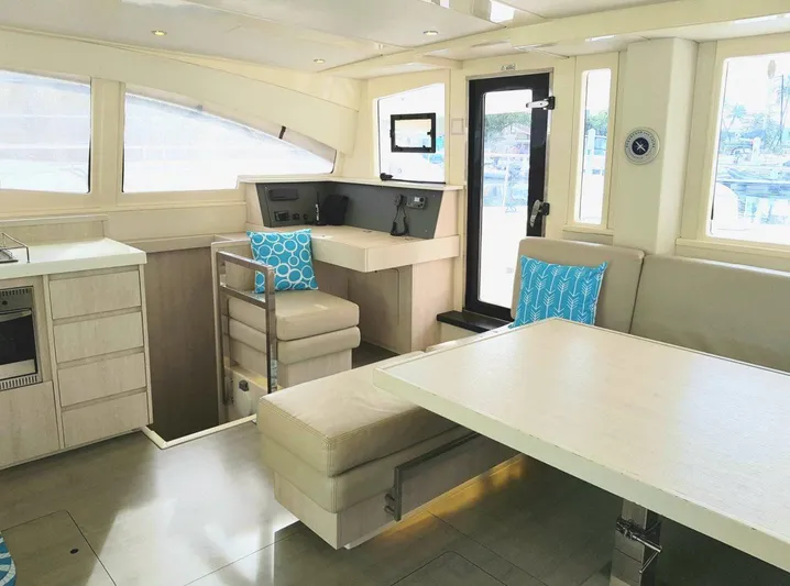 Dash Away Yacht Photos Pics Interior of 2015 Leopard 51 Powercat yacht with modern seating and dining area.
