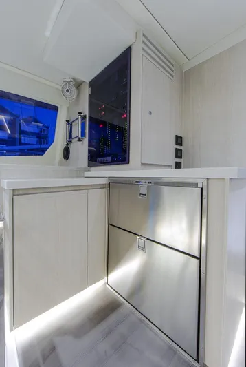 Dash Away Yacht Photos Pics Modern kitchen area in a 2015 Leopard 51 Powercat yacht with stainless steel appliances.