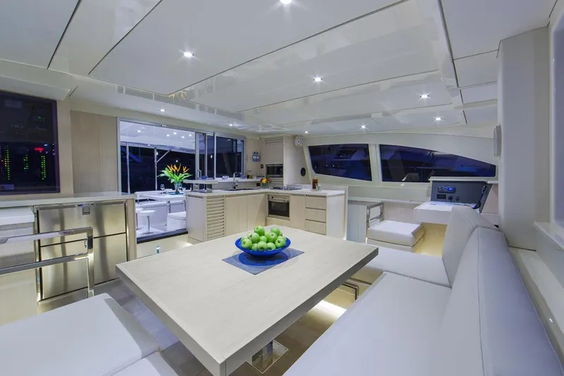 Dash Away Yacht Photos Pics Luxurious interior of 2015 Leopard 51 Powercat yacht with modern kitchen and dining area.