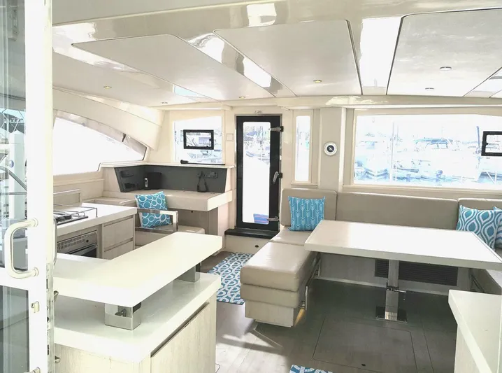 Dash Away Yacht Photos Pics Interior of 2015 Leopard 51 Powercat yacht with modern seating and kitchen area.