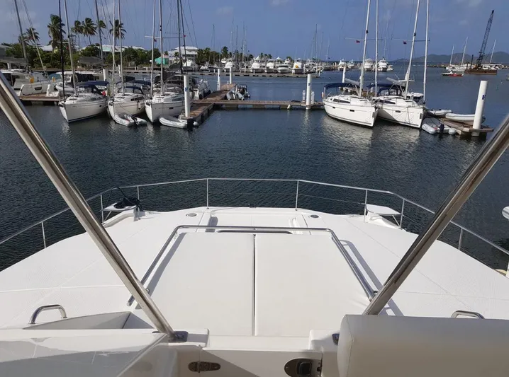 Dash Away Yacht Photos Pics 2015 Leopard 51 Powercat docked at marina with sailboats and calm water.