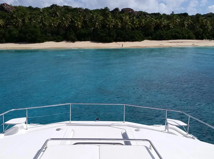 Dash Away Yacht Photos Pics Leopard 51 Powercat 2015 yacht approaching tropical beach with clear blue water.