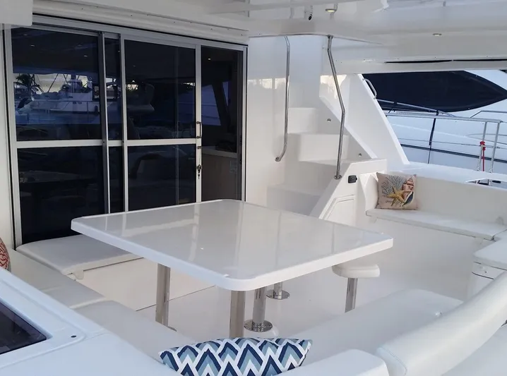 Dash Away Yacht Photos Pics 2015 Leopard 51 Powercat yacht interior with sleek white seating and table.