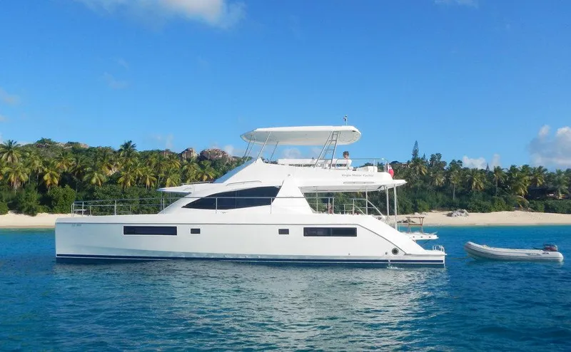 Dash Away Yacht Photos Pics 2015 Leopard 51 Powercat yacht anchored near tropical beach with clear blue skies.