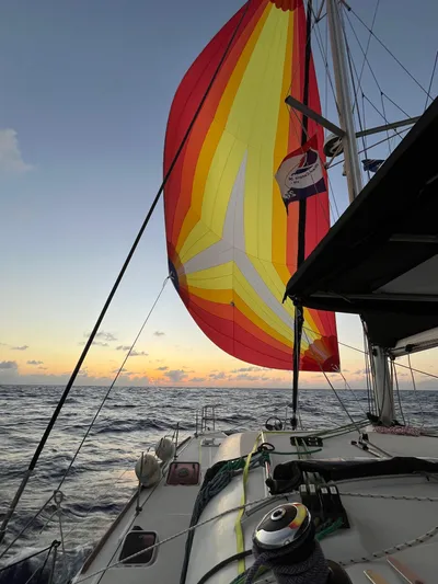 Myrto Yacht Photos Pics Lagoon 400 catamaran sailing at sunset with colorful spinnaker, 2012 model.