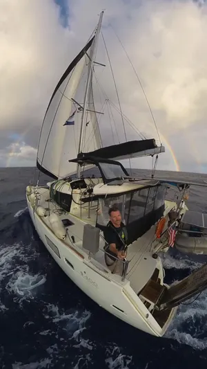 Myrto Yacht Photos Pics Sailing Lagoon 400 catamaran, 2012 model, on open sea with rainbow in background.