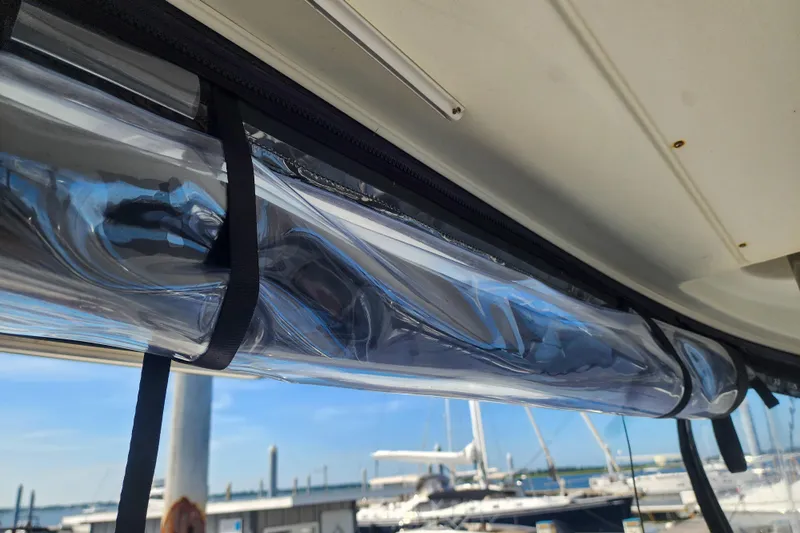 Myrto Yacht Photos Pics Clear plastic window on a 2012 Lagoon 400 catamaran, marina background.