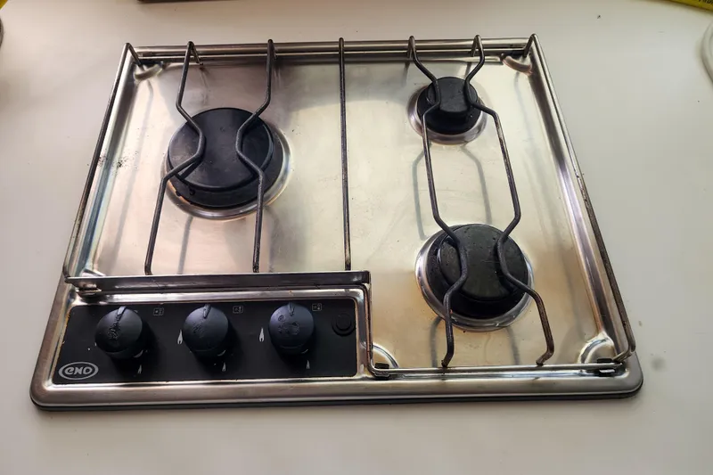 Myrto Yacht Photos Pics Three-burner stainless steel stove on Lagoon 400, 2012 model yacht kitchen.