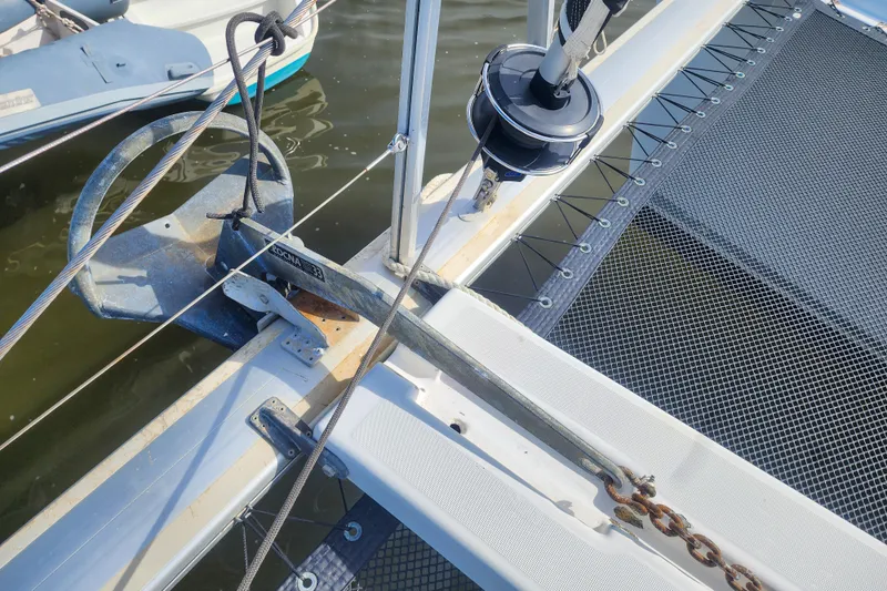 Myrto Yacht Photos Pics Catamaran Lagoon 400 (2012) anchor and netting detail, docked on calm water.