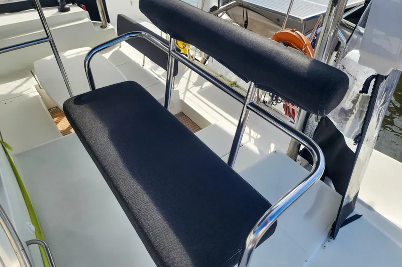 Myrto Yacht Photos Pics Helm seat on 2012 Lagoon 400 catamaran with stainless steel frame and black cushions.