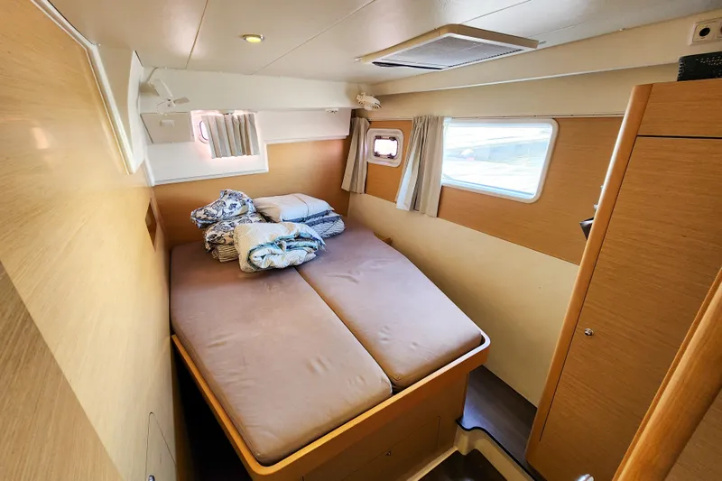 Myrto Yacht Photos Pics Cozy cabin interior of 2012 Lagoon 400 catamaran with double bed and windows.