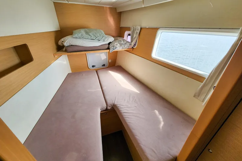 Myrto Yacht Photos Pics Interior cabin of a 2012 Lagoon 400 catamaran with cozy bedding and window view.