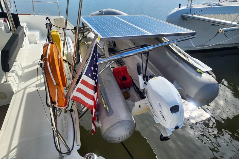 Myrto Yacht Photos Pics Lagoon 400 catamaran (2012) with solar panel, dinghy, and American flag on deck.