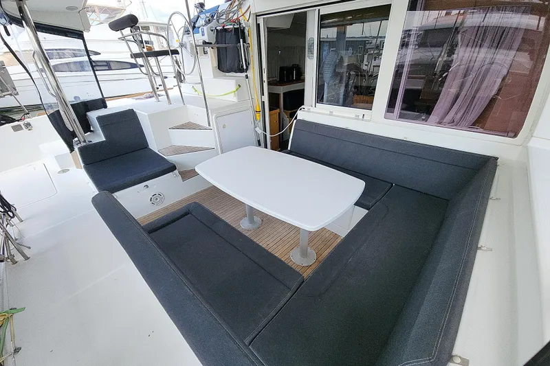 Myrto Yacht Photos Pics 2012 Lagoon 400 yacht cockpit with seating and table, featuring modern design.