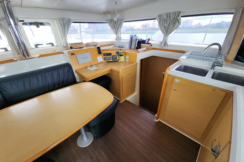 Myrto Yacht Photos Pics Interior of a 2012 Lagoon 400 catamaran with dining area and kitchen.