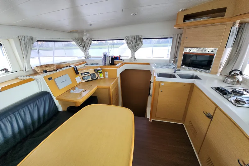 Myrto Yacht Photos Pics Interior of 2012 Lagoon 400 catamaran featuring kitchen and navigation area.