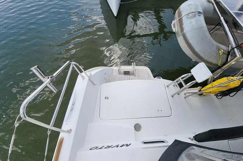 Myrto Yacht Photos Pics Lagoon 400 catamaran stern view with dinghy and water reflection, 2012 model.