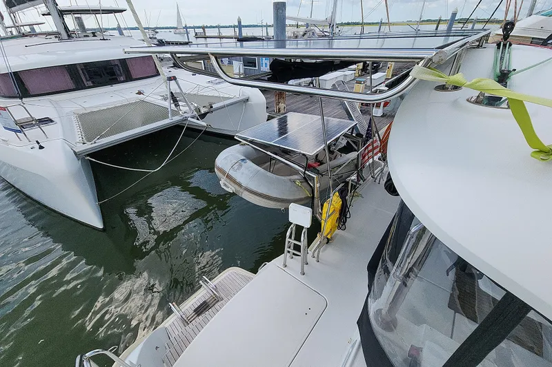 Myrto Yacht Photos Pics Docked Lagoon 400 catamaran from 2012 with solar panels and dinghy.