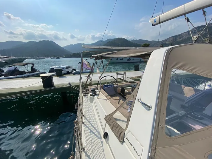  Yacht Photos Pics 2014 Beneteau Oceanis 48 yacht docked at scenic marina with mountains in background.