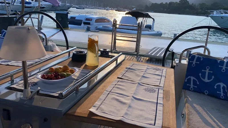  Yacht Photos Pics Beneteau Oceanis 48 yacht deck with fruit bowl and drink, sunset view, 2014 model.